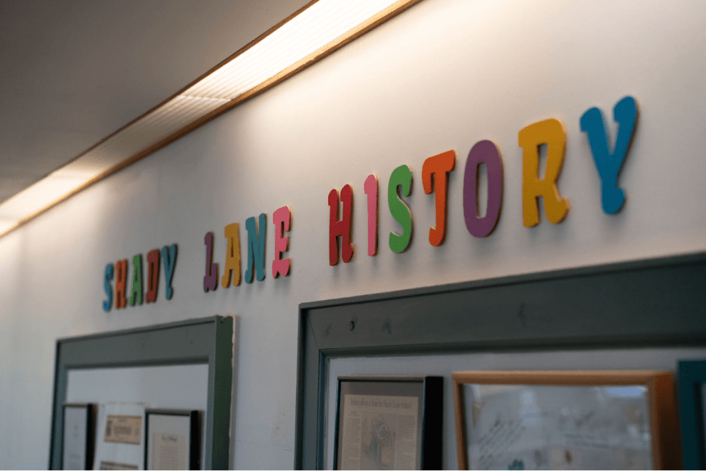A photo of a banner that reads Shady Lane History inside the main lobby of the school.